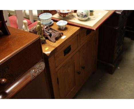 A small light oak sideboard 