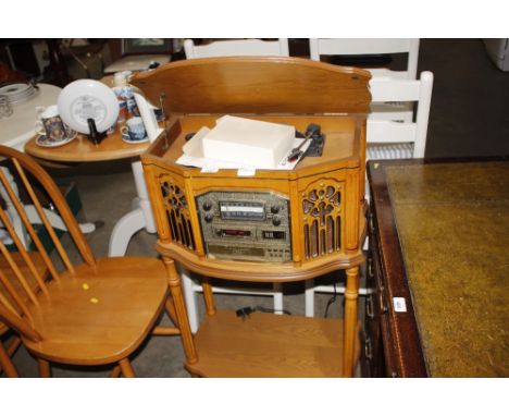 A vintage style cased stereo system on stand