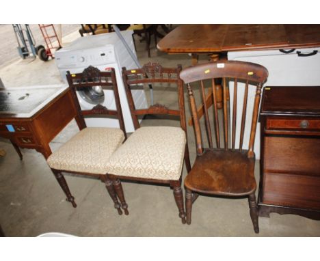 An elm seated stick back chair together with a pair of mahogany upholstered chairs raised on turned supports