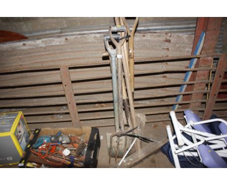 A bundle of long handled gardening tools