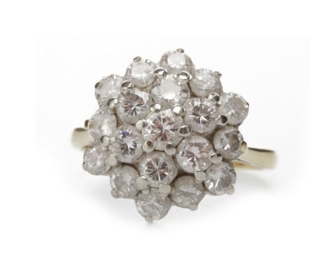 DIAMOND CLUSTER RINGthe tiered bezel 15mm wide and with caw set round brilliant cut diamonds totalling approximately 1.20 car