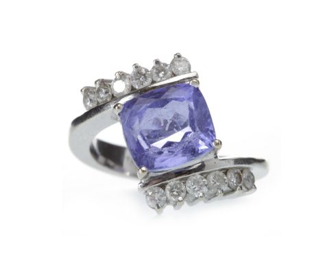 IMPRESSIVE TANZANITE AND DIAMOND RINGset with a central cushion shaped tanzanite 9.5mm long, in a twist setting and on diamon