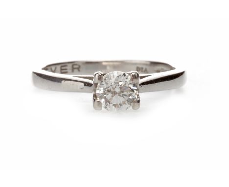 DIAMOND SOLITAIRE RING with a four claw set round brilliant cut diamond of approximately 0.36 carats, marked 750, size K, 2.8