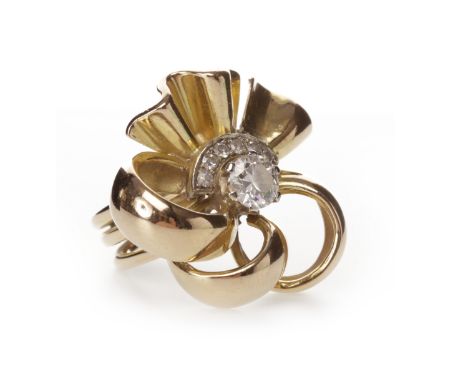 FLORAL MOTIF DIAMOND RINGset with a central round brilliant cut diamond of approximately 0.60 carats, within a crescent shape