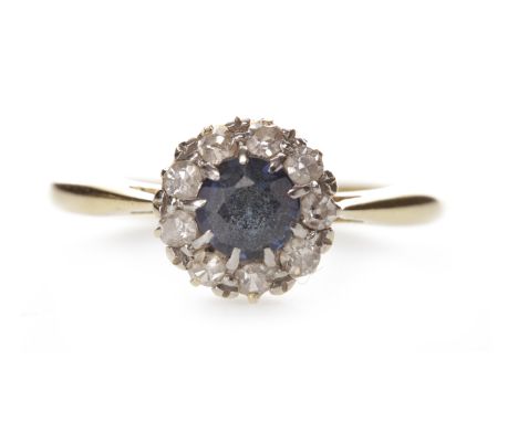EIGHTEEN CARAT GOLD BLUE GEM SET AND DIAMOND RINGset with a central round blue gem within a halo of round brilliant cut diamo