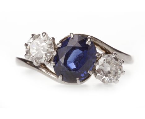 EIGHTEEN CARAT GOLD BLUE GEM AND DIAMOND RINGthe oval blue gem flanked by two round brilliant cut diamonds, on twist shoulder