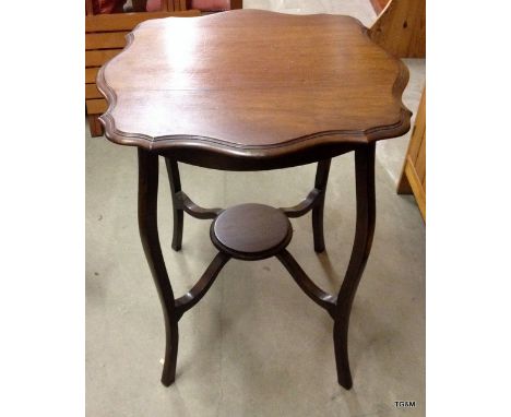 A mahogany pie crust lamp table on tapered legs