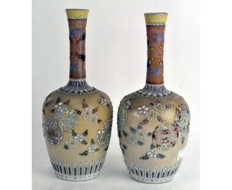 A pair of Japanese ceramic vases, of globular form, with tapering necks, decorated with polychrome floral scenes, 24cm high
