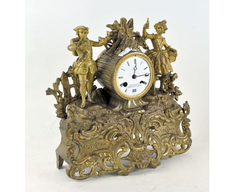 A late 19th-early 20th Century mantel clock, the gilt cast metal frame modelled as a man and woman dancing and drinking, whit