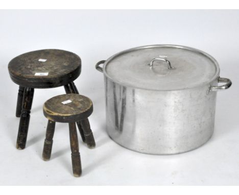 Two milking stools, one of three and one of four legs, maximum height 24cm, a large lidded metal saucepan, and a white and bl