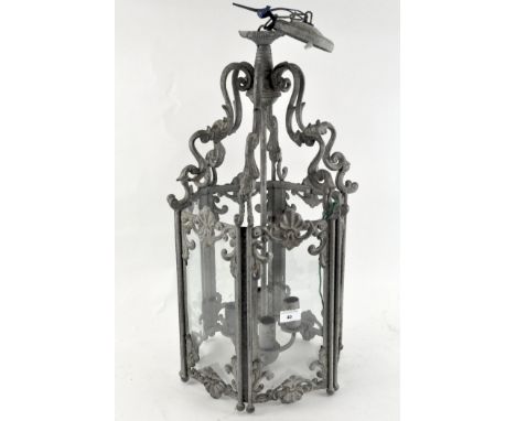 A large ornate metal hanging lantern, of hexagonal form, each side fitted with a glazed panel, four sconces, approximately 63