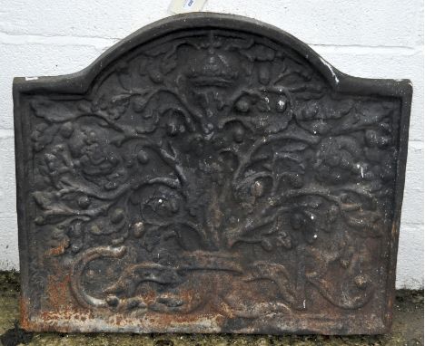 A large cast metal fire back with domed top, moulded with an oak tree and the initials C and R, 72cm x 87cm