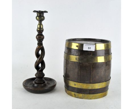 An oak coppered barrel, height 20cm, together with a turned barley twist candlestick, height 30cm