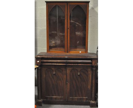 A Victorian mahogany bookcase in the Gothic style, with two glazed double doors above two frieze drawers and two panelled cup