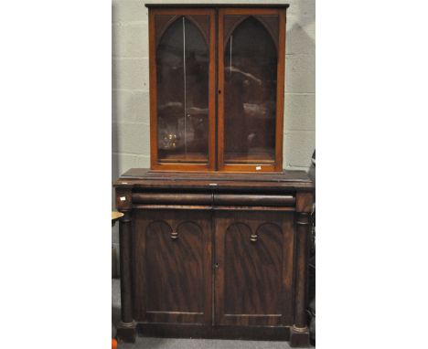 A Victorian mahogany bookcase in the Gothic style, with two glazed double doors above two frieze drawers and two panelled cup