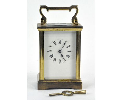An early 20th century brass and bevelled edge glass cased carriage clock with Roman numerals to face, height (without handle)