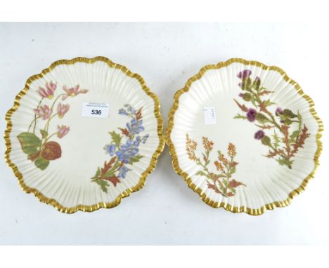 Two Worcester plates, with fluted gilt rims and floral decoration on a cream background, diameter 22cm