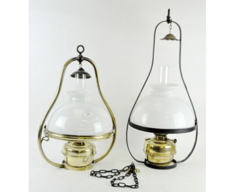 Two 20th Century oil ceiling lamps, ceramic shades and flutes supported by metal frames, height of largest 72cm