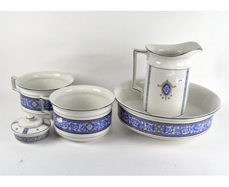 A ceramic wash set comprising a jug, bowl and two chamber pots, all decorated with a printed blue design
