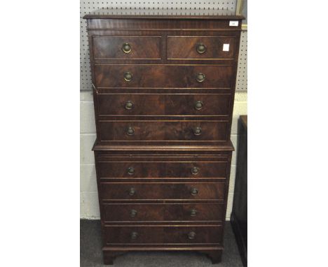 An early 20th century mahogany chest on chest on bracket feet, with two small drawers over three to the top, and a brushing s
