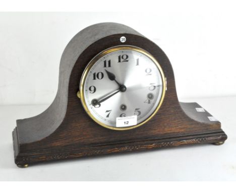 A 1930's oak cased mantle clock, marked to movement 'Fontenoy Made in France', the silvered dial with Arabic numerals denotin