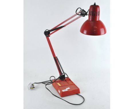 A red anglepoise style lamp, on a rectangular base, height (fully extended) 84cm