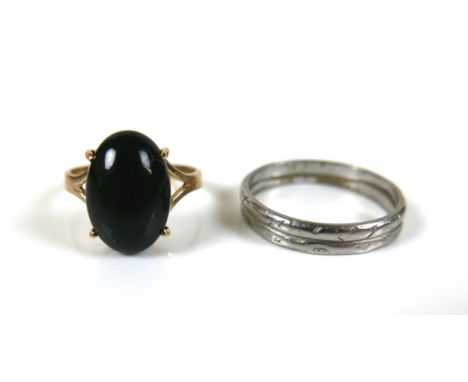 A platinum band, size R/S, 4.6g together with a 14ct gold black stone dress ring, size M, 2.4g overall. (2) 