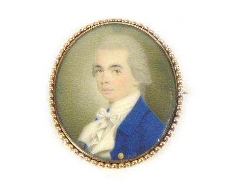 A yellow metal brooch with a portrait miniature of Regency gentleman, 20.3g overall, 3.7 by 4.5cm overall.