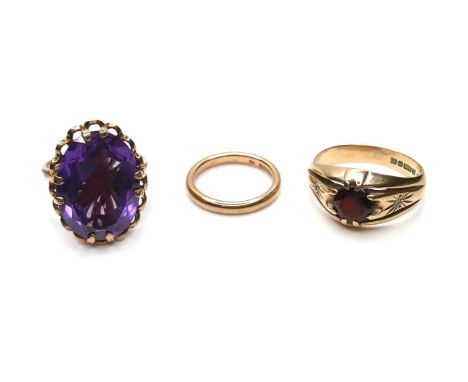 Three 9ct gold rings, comprising a gypsy set red stone ring, the round cut stone, 6.5mm, with two round cut white stone chips