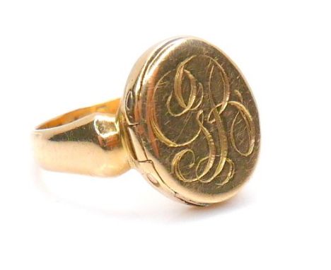 A 19th century 18ct yellow gold ring, possibly for snuff or poison, the oval face engraved 'GR', and with hinged compartment,