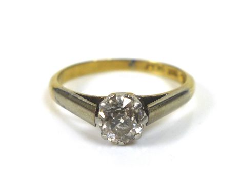 An 18ct gold diamond solitaire ring, with platinum mounts, the round faceted cut stone, 5.2 by 3.5mm, approximately 0.62ct, i