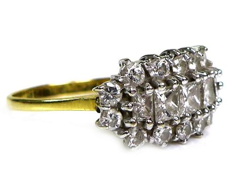 A yellow gold and diamond dress ring, set with a row of five graduating sqaure and rectangular cut stones, central stone 3.5 