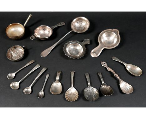 A group of mixed silver and white metal items, including caddy spoons, tea strainers, salt spoons, a toddy ladle bowl, and a 