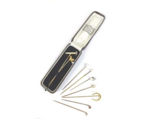 A group of nine early 20th century and later gold and yellow metal stick pins, including an 18ct gold pin with cat and pearl 