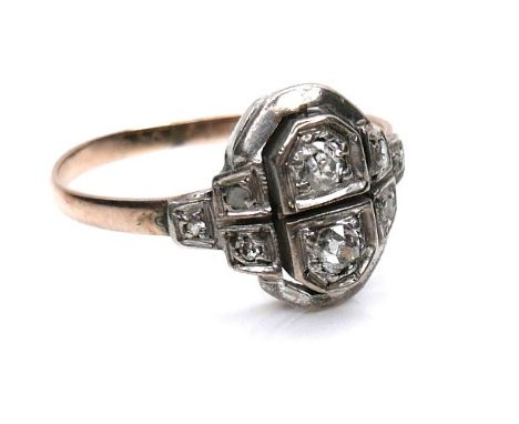 An Art Deco 14k gold and diamond ring, the two principle round cut diamonds 2.5 by 1.7mm, flanked by six small diamonds, size