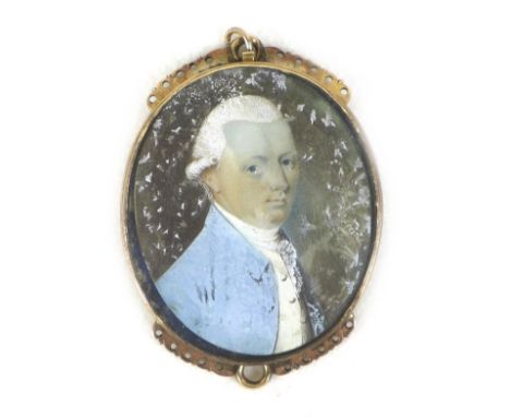 A yellow metal pendant with a portrait miniature of a Regency gentleman, unsigned, 12.8g overall, 4.2 by 3cm overall.