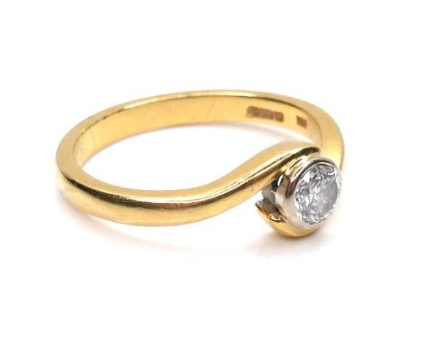 An 18ct yellow gold solitaire diamond crossover ring, the round brilliant cut stone, 4.0 by 2.5mm, 0.25ct, maker SDJ, shank 2