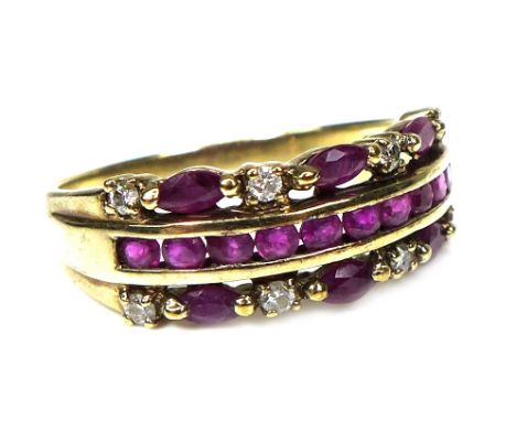 A 9ct gold ruby and diamond cluster ring, with eight round cut small diamonds, each approximately 1mm diameter, with six oval