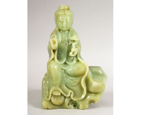 A GOOD HEAVY JADE FIGURE of a seated Guanyin, 17cm high.