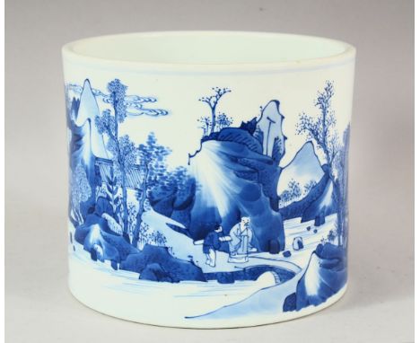 A KANGXI BLUE AND WHITE BRUSH POT, the sides with a continuous scene of trees, mountains and figures, 18cm diameter, 15cm hig