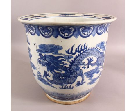 A LARGE CHINESE BLUE AND WHITE PLANTER, the body decorated with dragon and phoenix, (AF), 32cm high, 36cm diameter.
