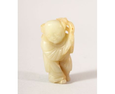 A SMALL CHINESE CARVED JADE FIGURE OF A BOY, possibly Ming Dynasty, 5.5cm high.