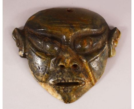 A CHINESE CARVED MOSS JADE HONG SHAN MASK - 20cm wide
