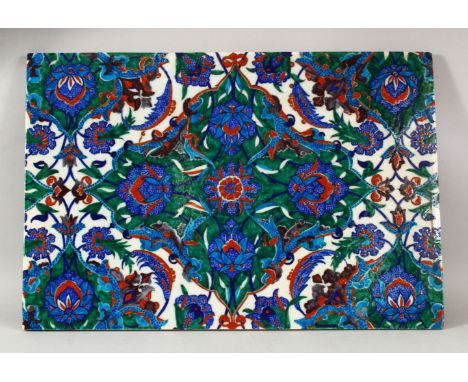 A LARGE POSS 19TH CENTURY IZNIK POTTERY TILE - decorated with a blue ground with floral motif decoration, 48.5cm x 32cm