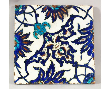 A 17TH CENTURY TURKISH OTTOMAN PORCELAIN TILE - decorated with a blue &amp; white ground with floral decoration, 27cm