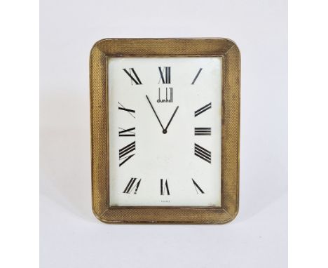 Dunhill brass desk clock, rectangular with rounded corners, engine-turned frame to the white enamel dial, marked France, labe
