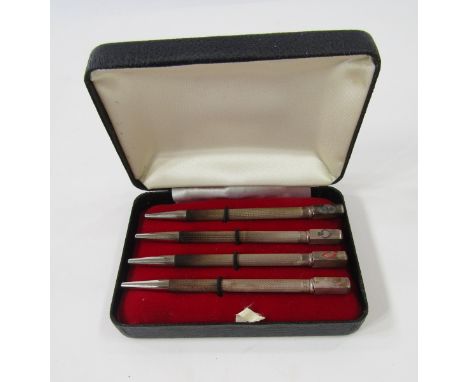 Set of four sterling silver enamelled bridge pencils, each engine-turned with rectangular terminal enamelled with a card suit