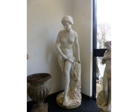 A LARGE COMPOSITE GARDEN FIGURE OF A LADY LEANING ON A TREE TRUNK.