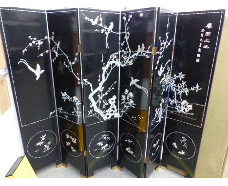 AN ORIENTAL MOTHER OF PEARL INLAID BLACK LACQUER SIX PANEL FLOOR SCREEN. EACH PANEL 182 x 40cms
