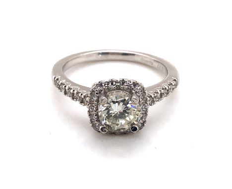 A HALLMARKED PLATINUM AND DIAMOND CLUSTER RING. THE PRINCIPLE DIAMOND APPROX 0.95cts, THE HALO AND SHOULDERS APPROX 0.30cts. 